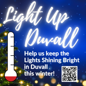 A holiday-themed graphic reads "Light Up Duvall. Help us keep the Lights Shining Bright in Duvall this winter!" with a thermometer graphic, Christmas tree, and QR code. - Duvall Chamber